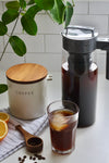 One Size Black Pitcher Lid and Handle. Pitcher near coffee canister and glass of cold brew coffee.